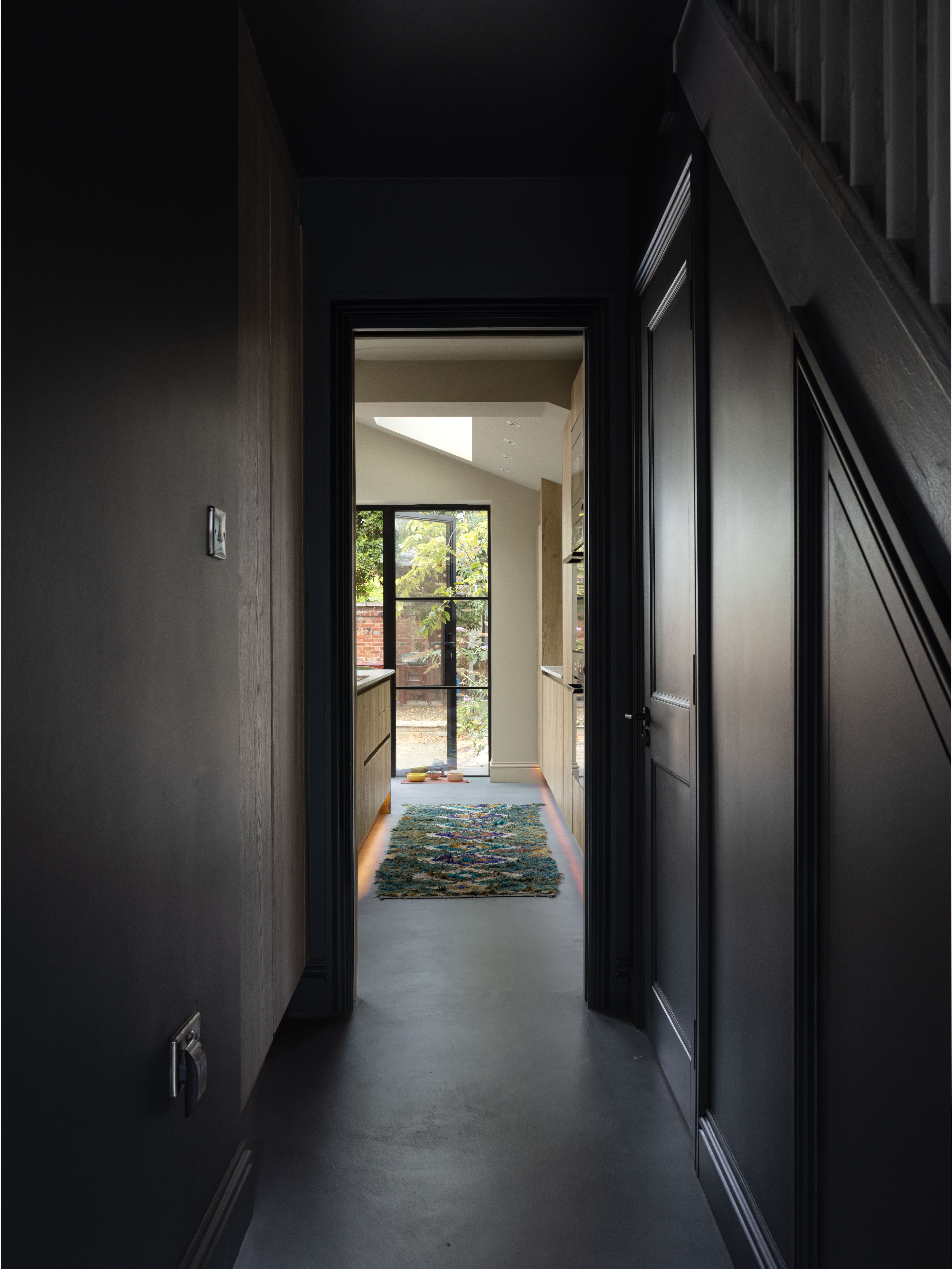 Dark hallway leading into the bright kitchen extension at Ewhurst Road