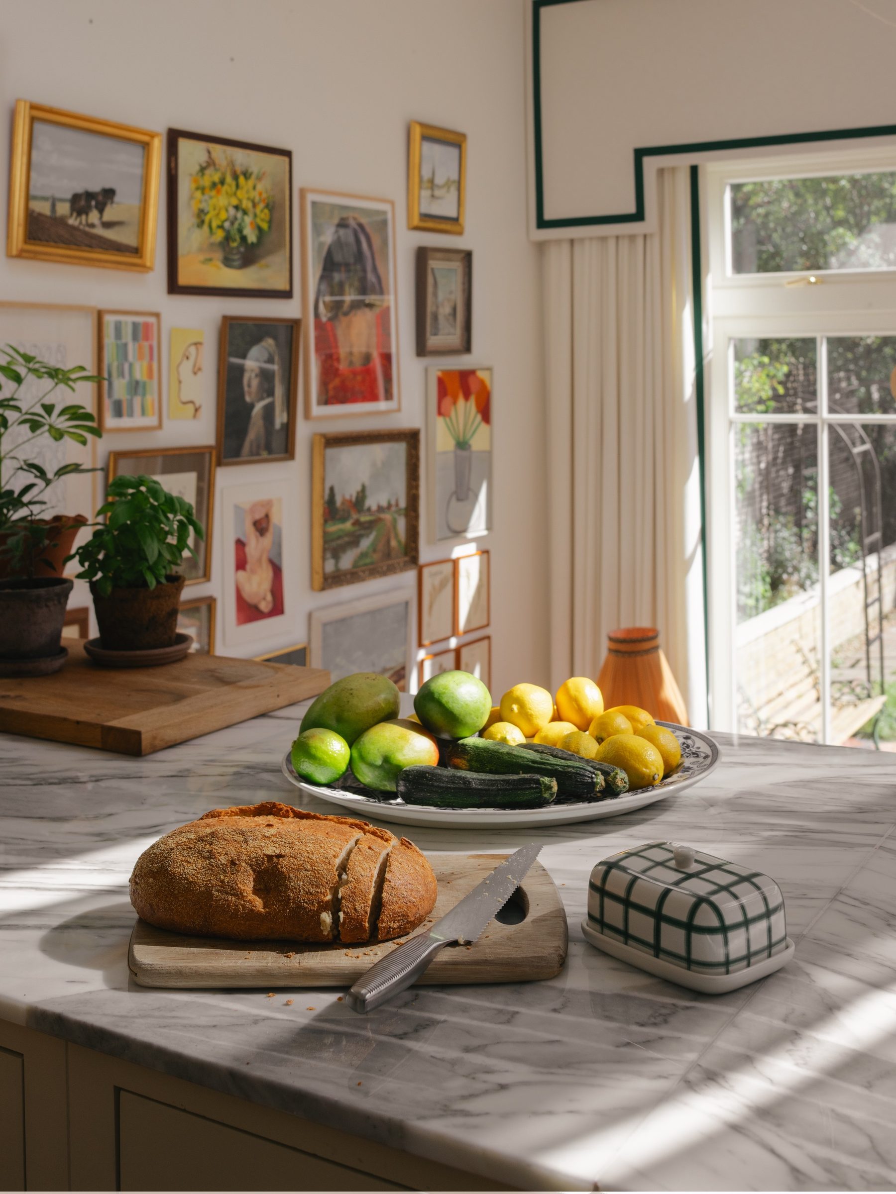 Bread and fruit on the marble island in morning sun