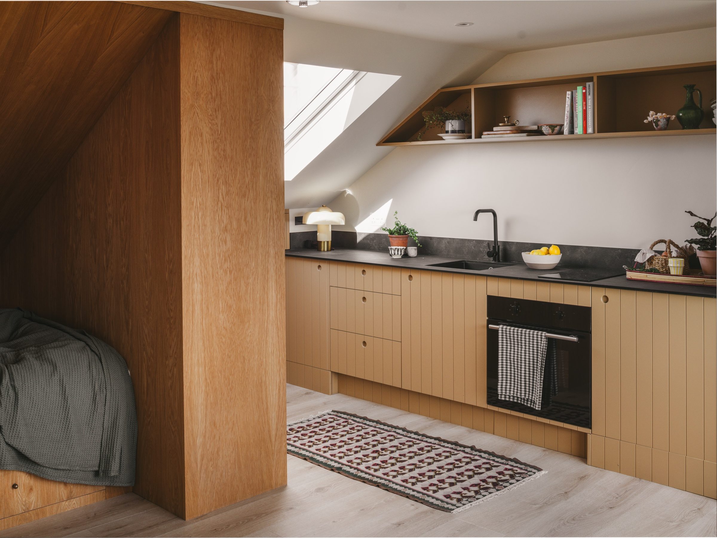 Oak-lined guest studio and kitchen in the loft