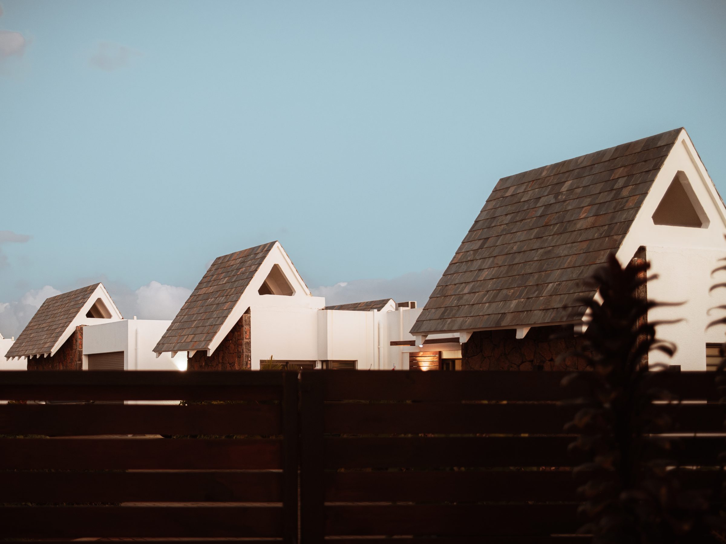 White villas with dark pitched roofs against the sky