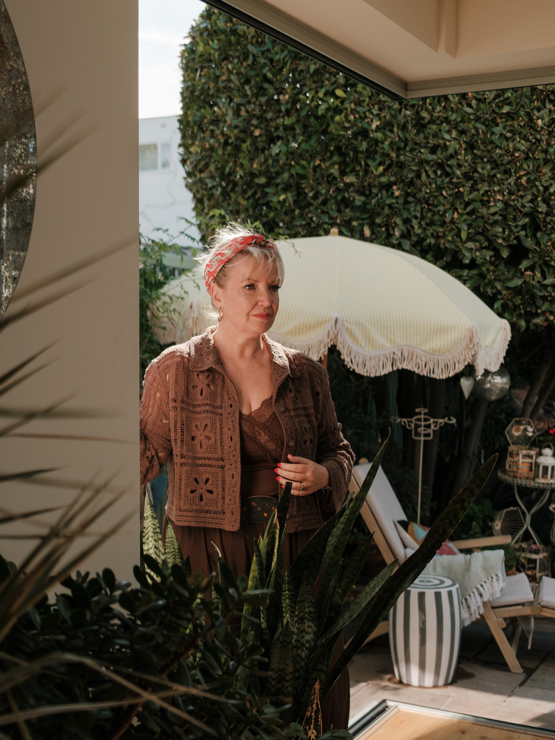 The owner standing in the garden beside the open corner