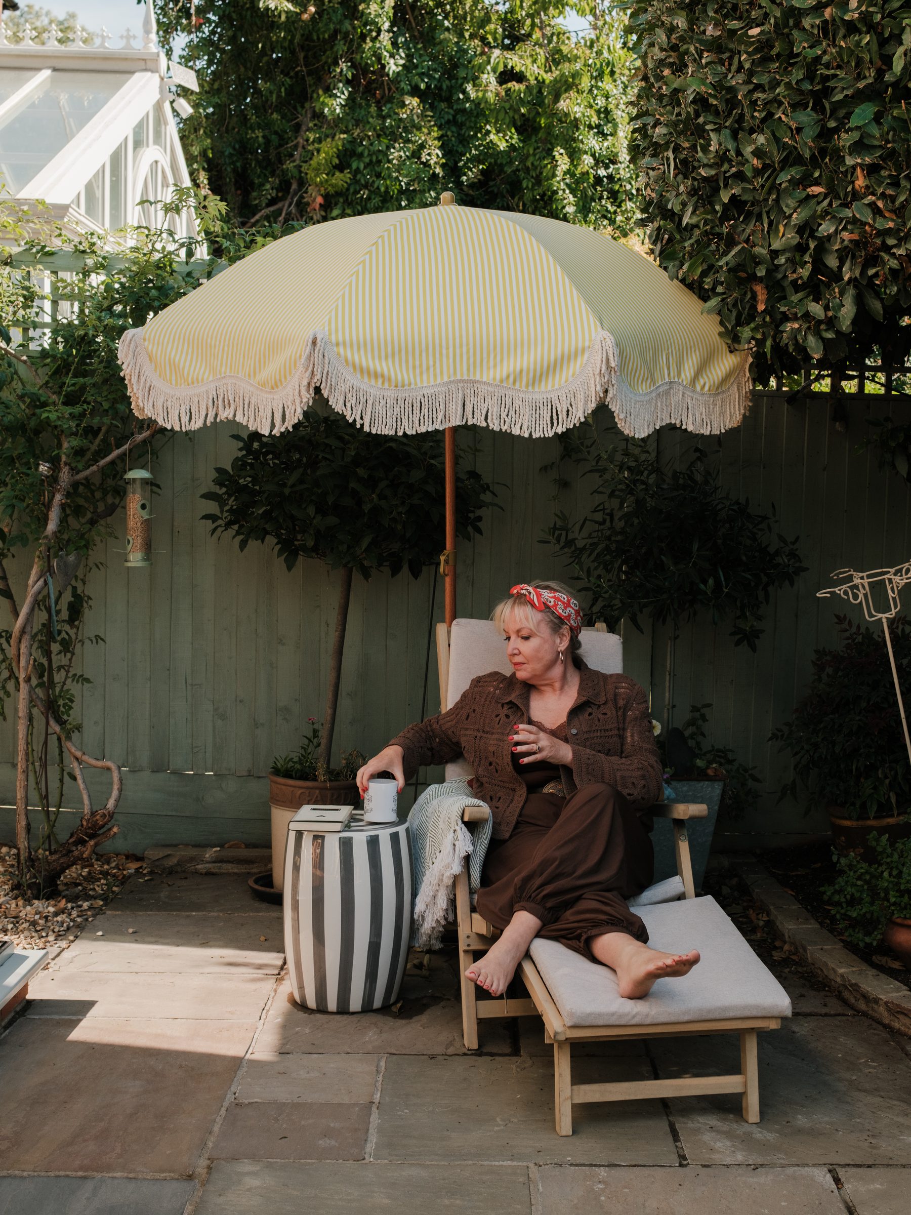 The owner relaxing under a parasol in the garden